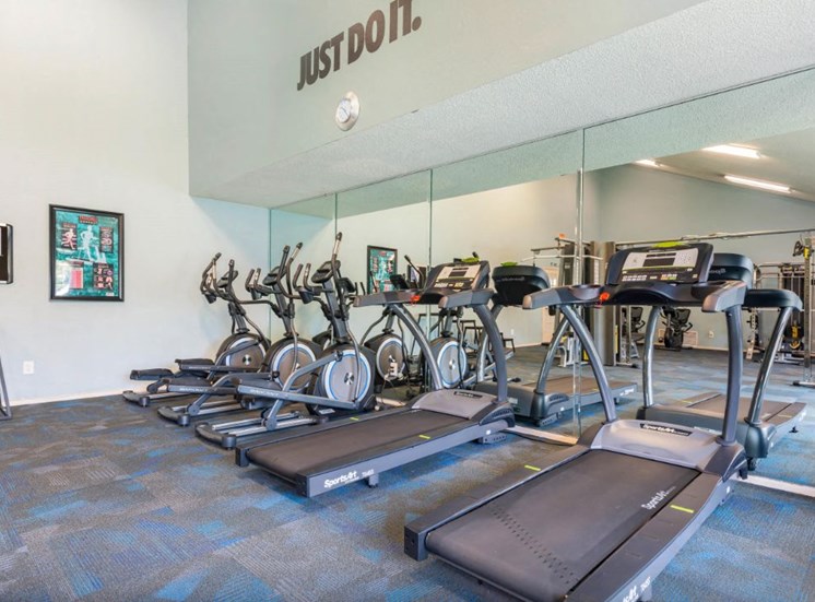 Fitness center with cardio equipment and large mirrors
